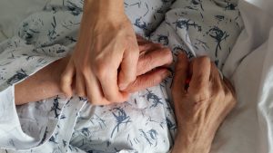 holding elderly family member s hand in hospital d 2022 11 01 23 58 13 utc
